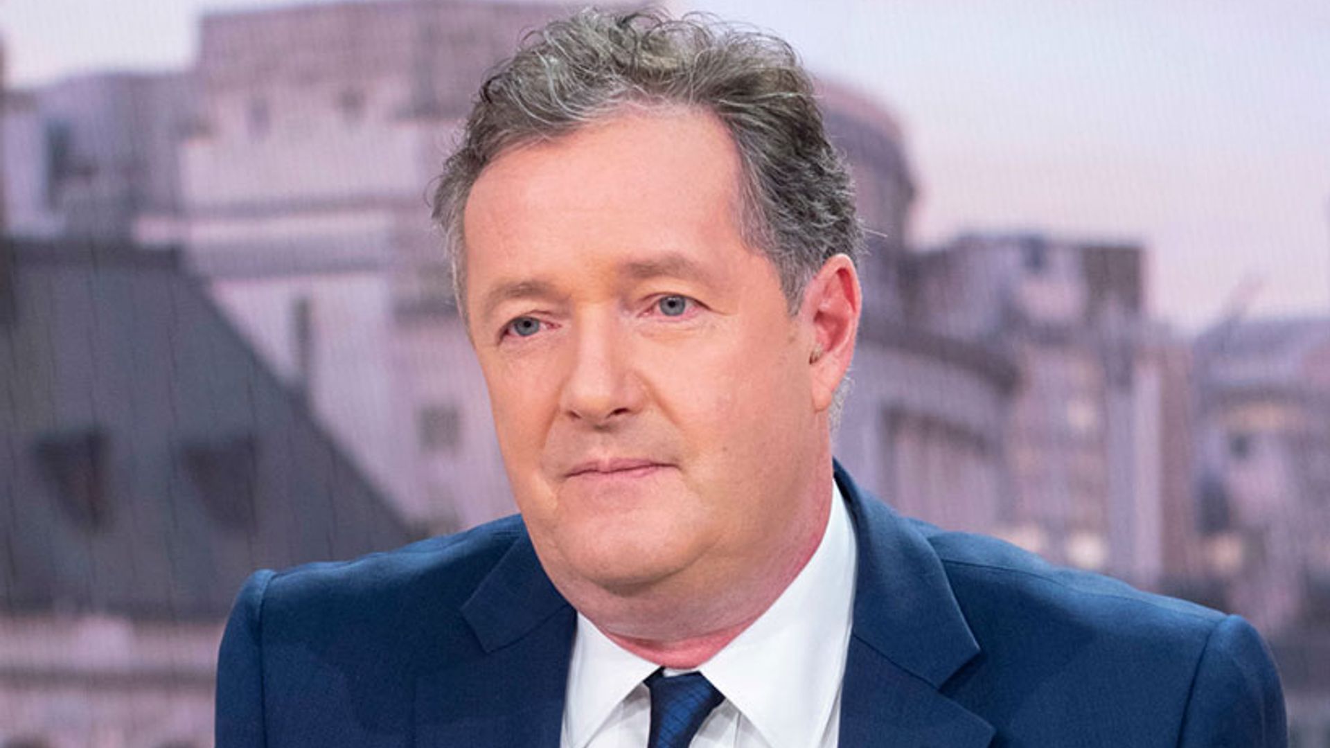 Piers Morgan looking sombre while presenting the news