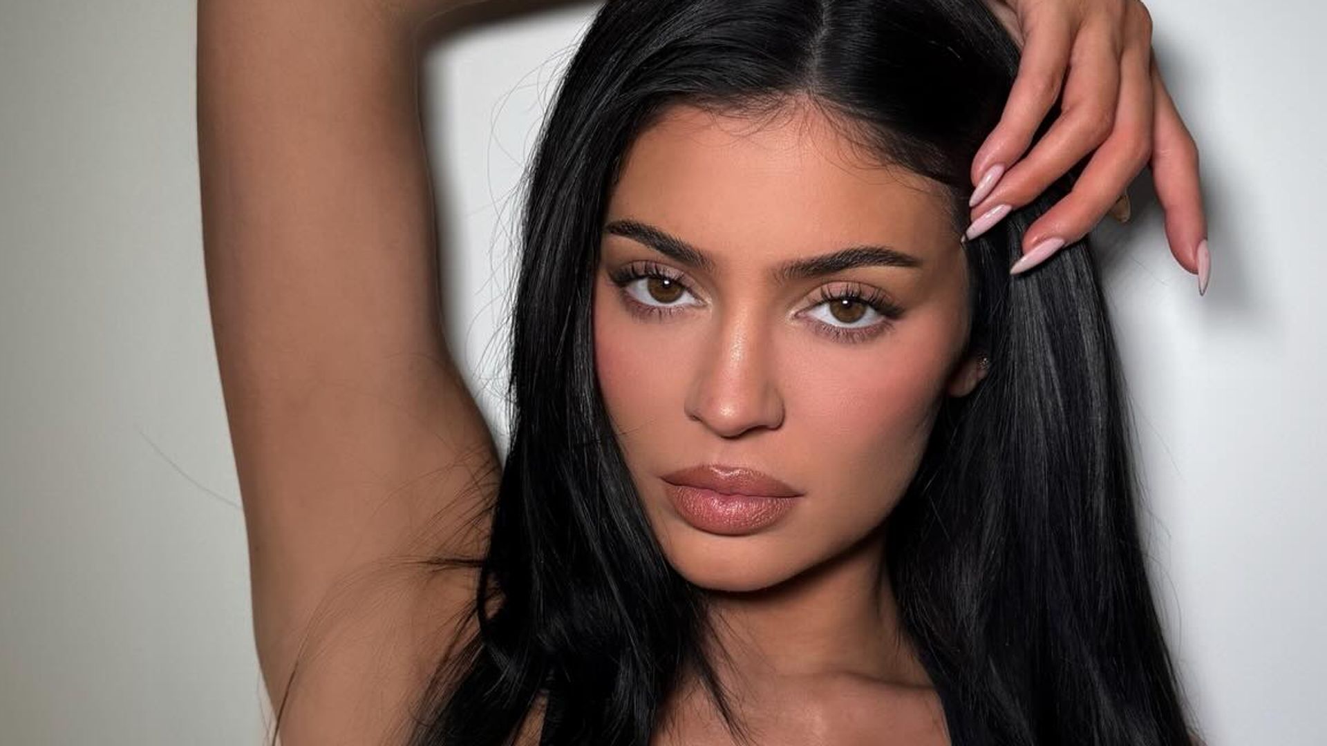 Kylie Jenner poses for a photo in a black sports bra