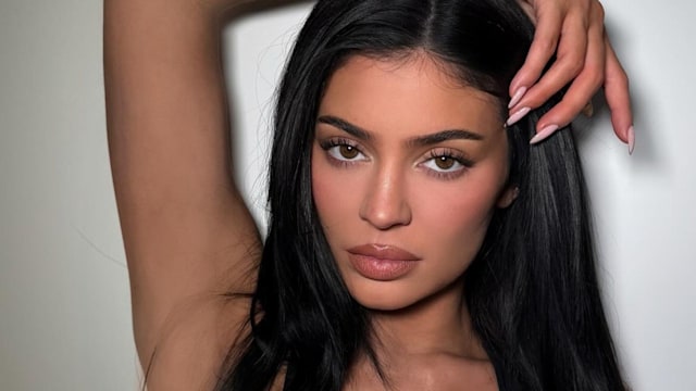 Kylie Jenner poses for a photo in a black sports bra