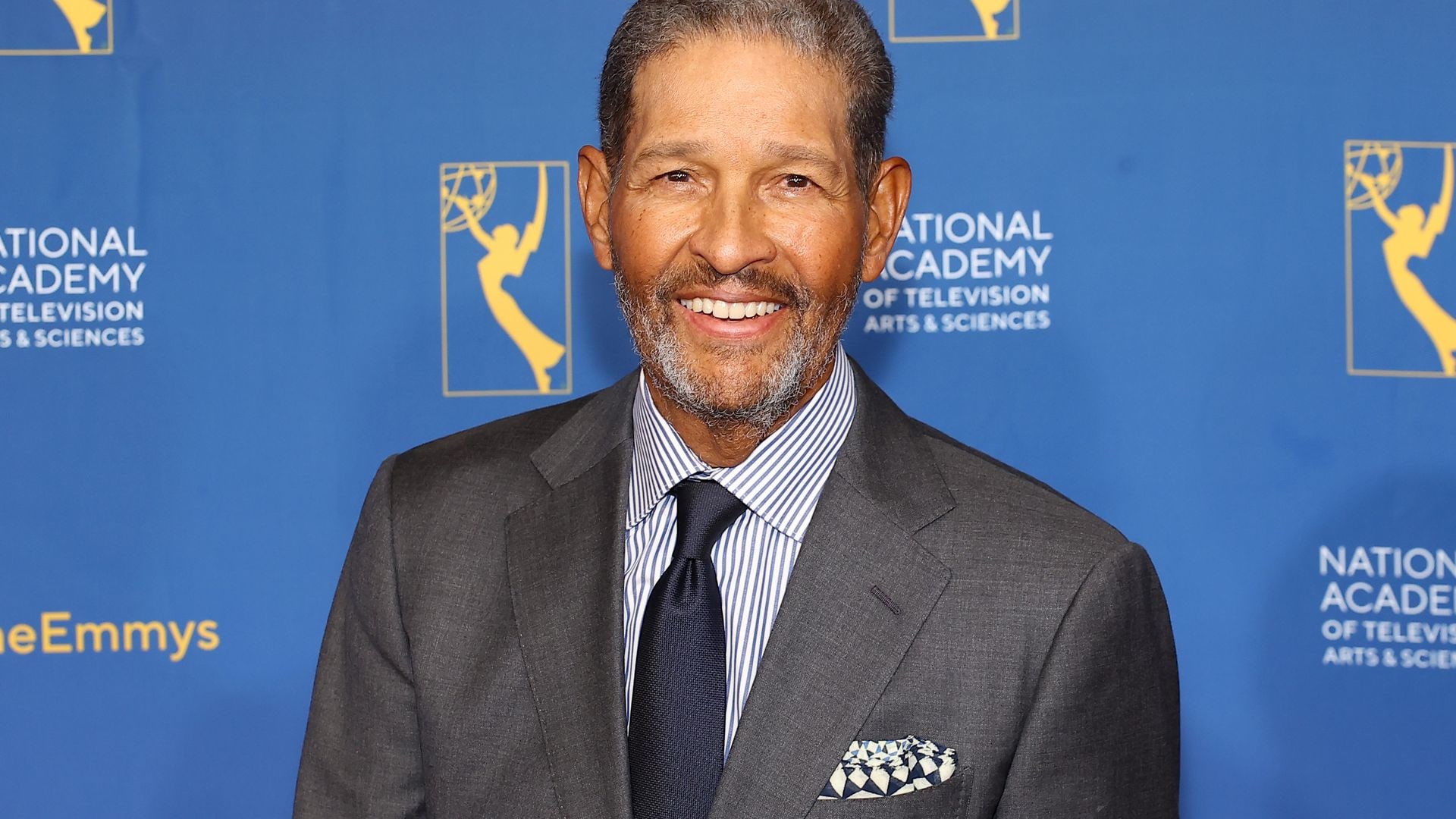 bryant gumbel smiling in gray suit