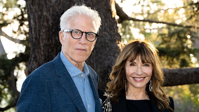 Ted Danson and Mary Steenburgen pose outside by a tree