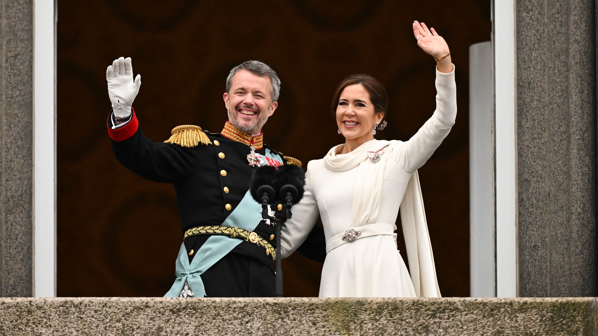 King Frederik X and Queen Mary of Denmark wave from balcony