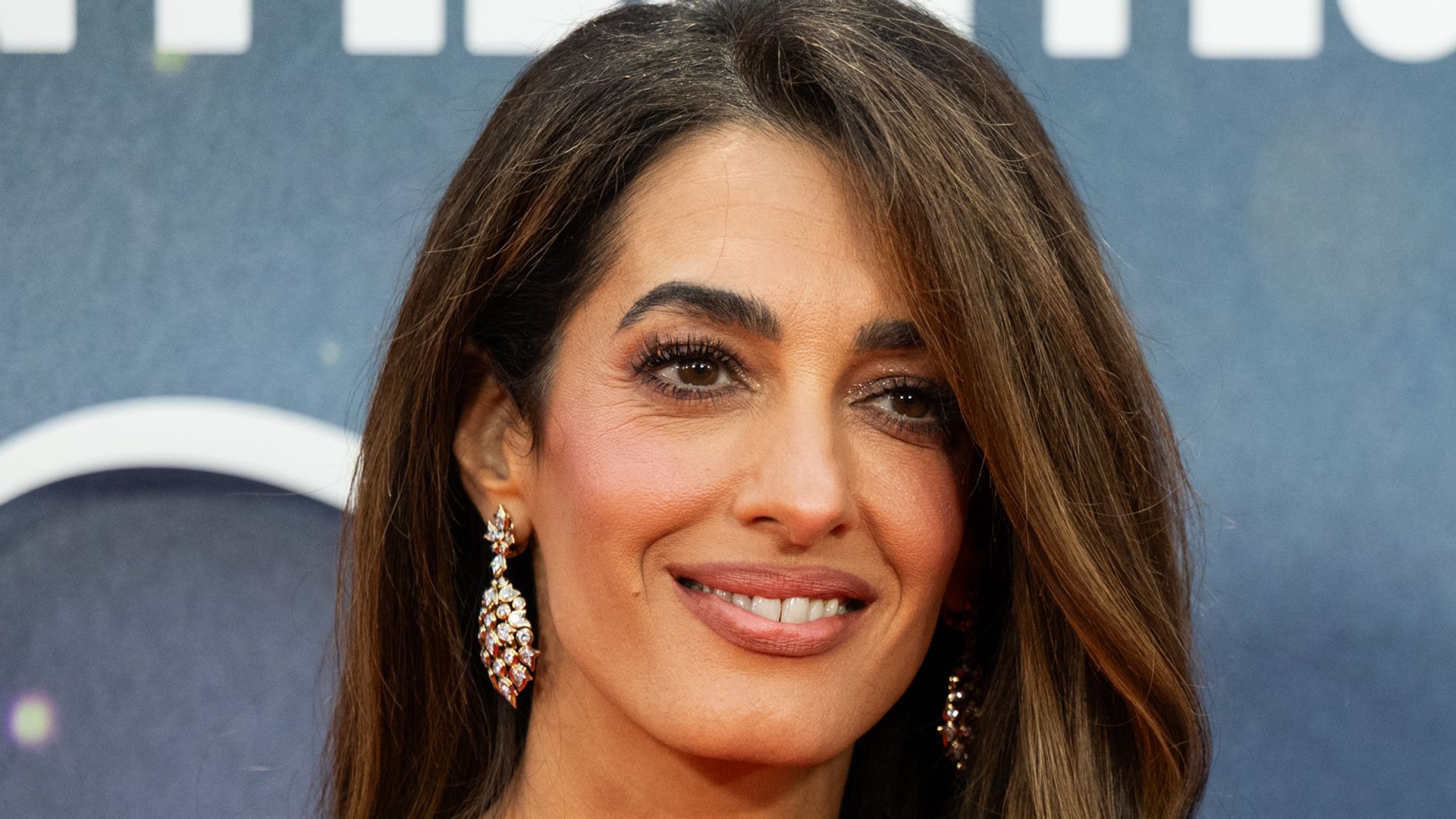 Amal Clooney in strapless pink dress and George Clooney in suit