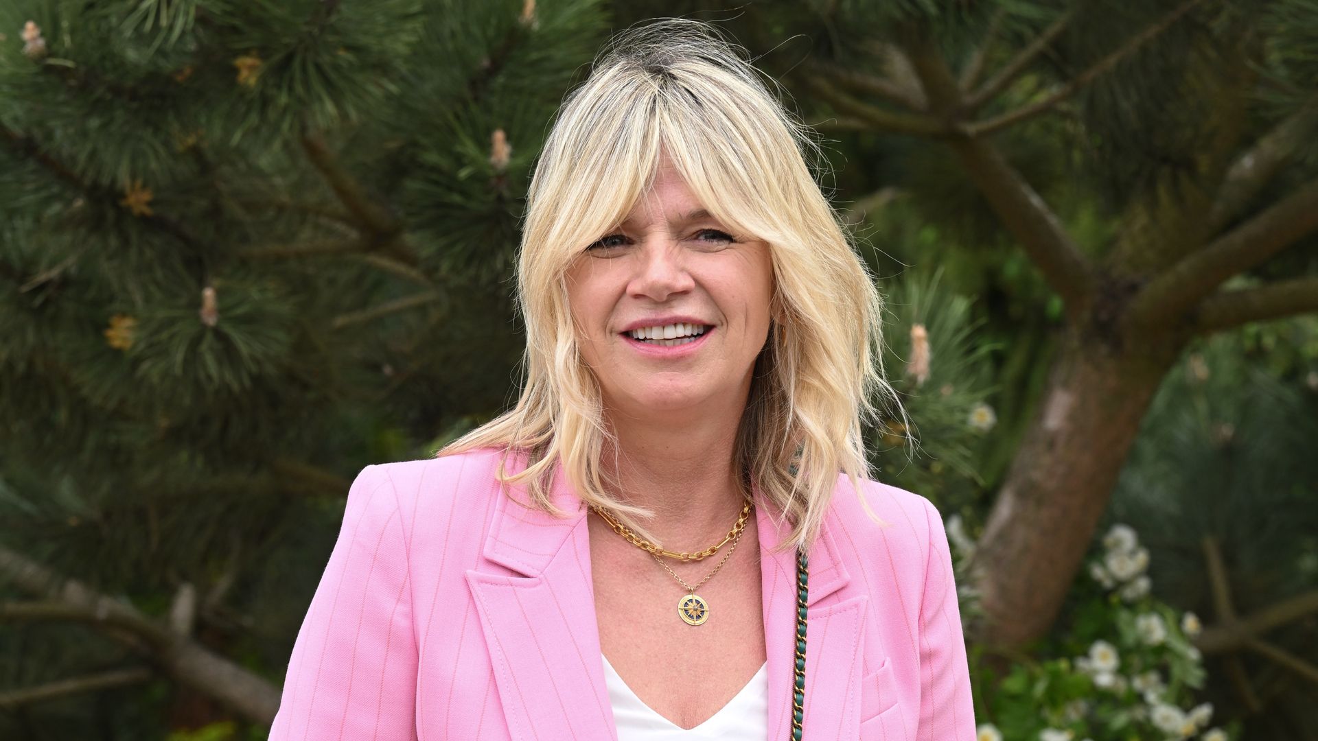 Zoe Ball in a pink suit wearing a green bag