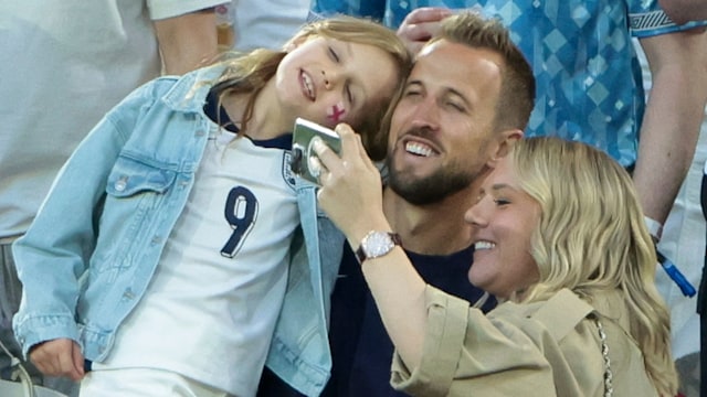 Harry Kane and Kate Kane smiling with their daughter