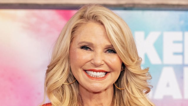 Christie Brinkley in orange pantsuit 
