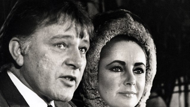 Black-and-white photo of Richard Burton and Elizabeth Taylor at a press conference