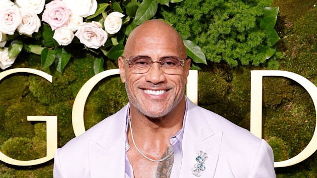 Dwayne Johnson in purple jacket on the red carpet