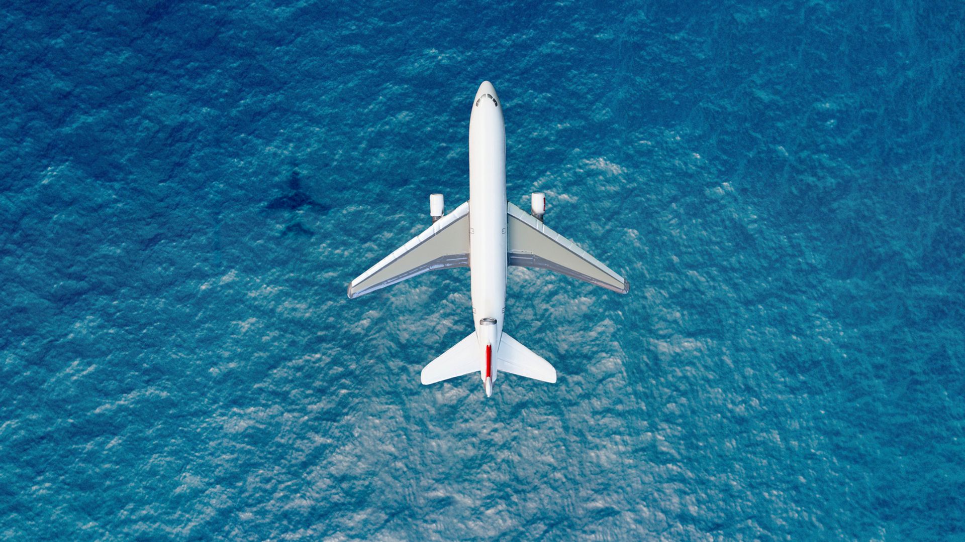 Airplane flies over a sea