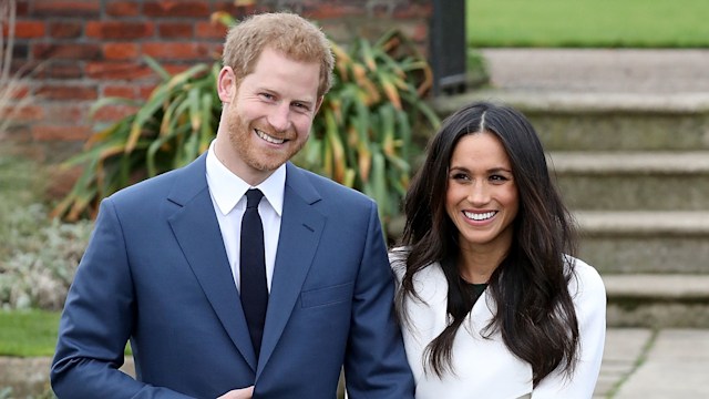 Prince Harry and actress Meghan Markle stand in gardens at palace