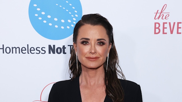 Kyle Richards in plunging black dress 