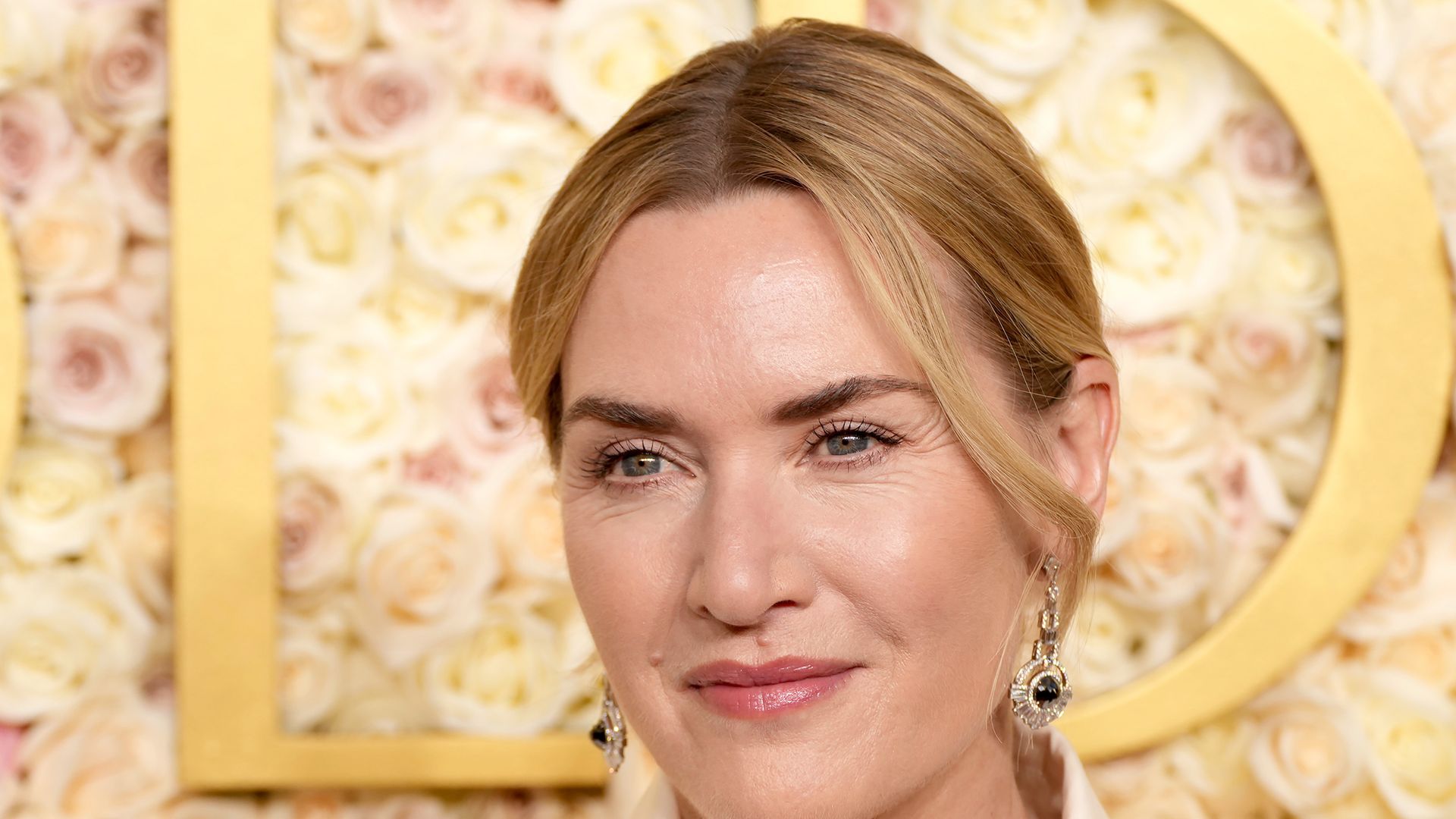 Kate Winslet up close in white suit jacket
