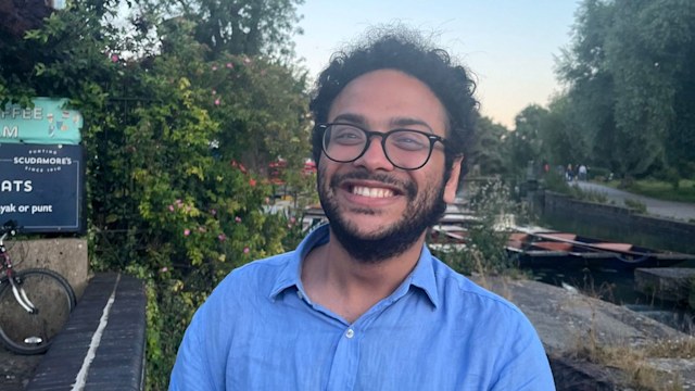 young man smiling in a blue shirt