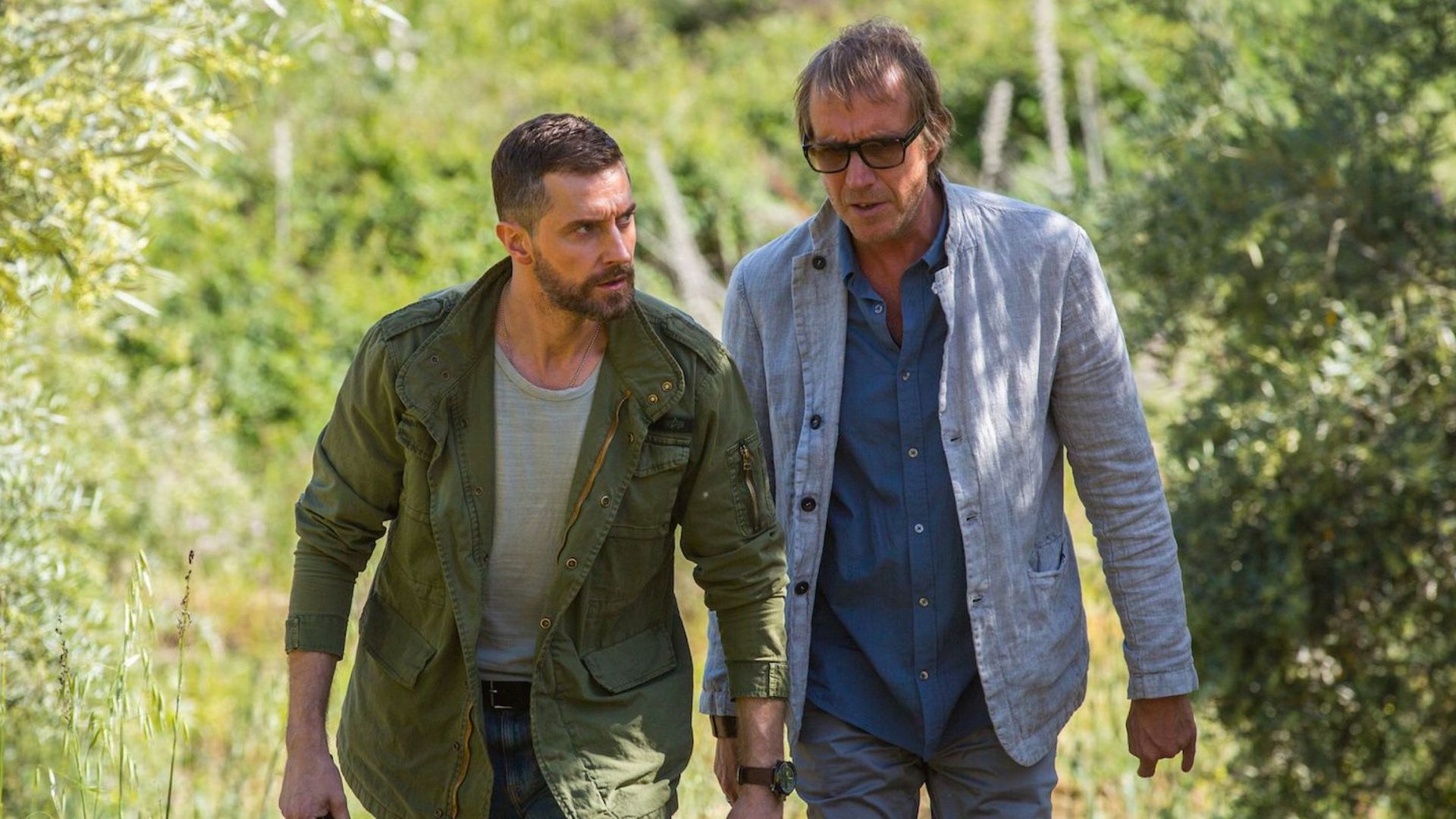 two men walking through field