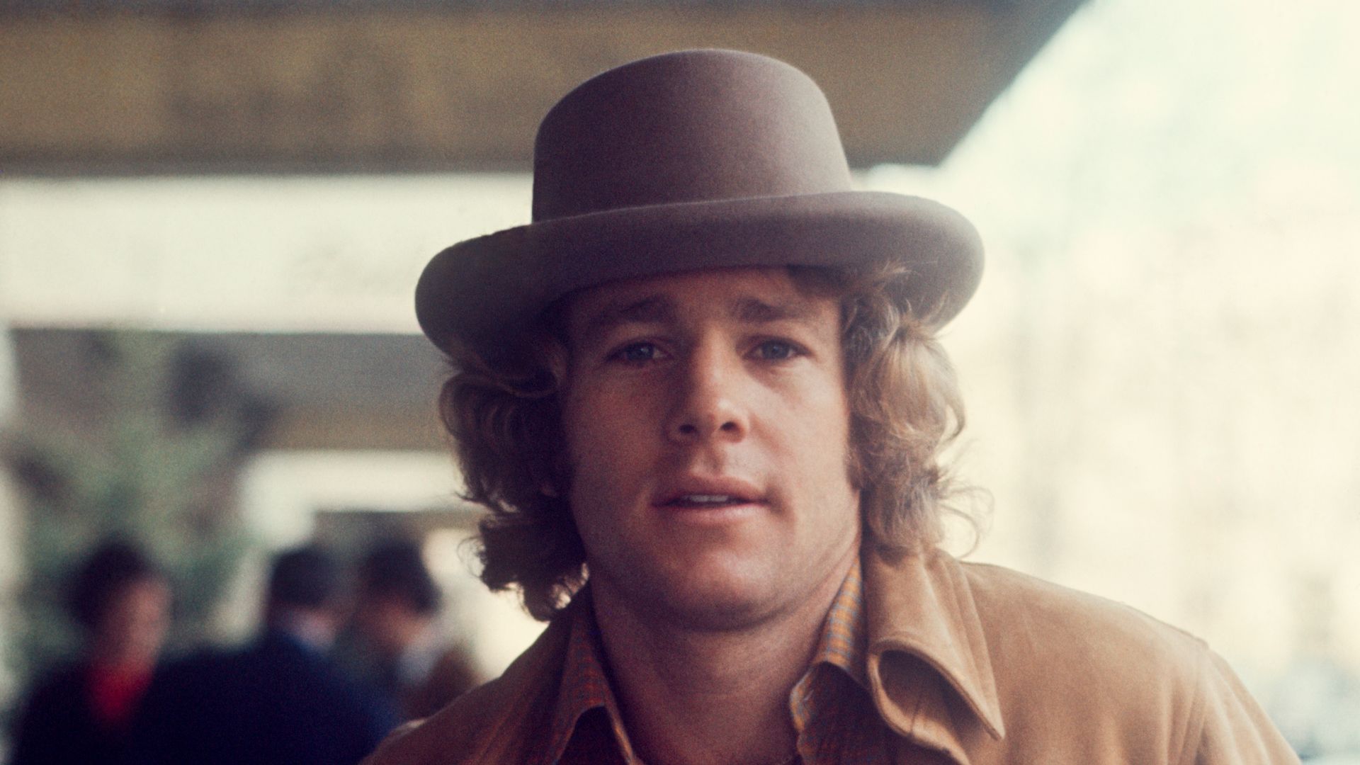 Ryan O'Neal in a hat and suede jacket; circa 1980