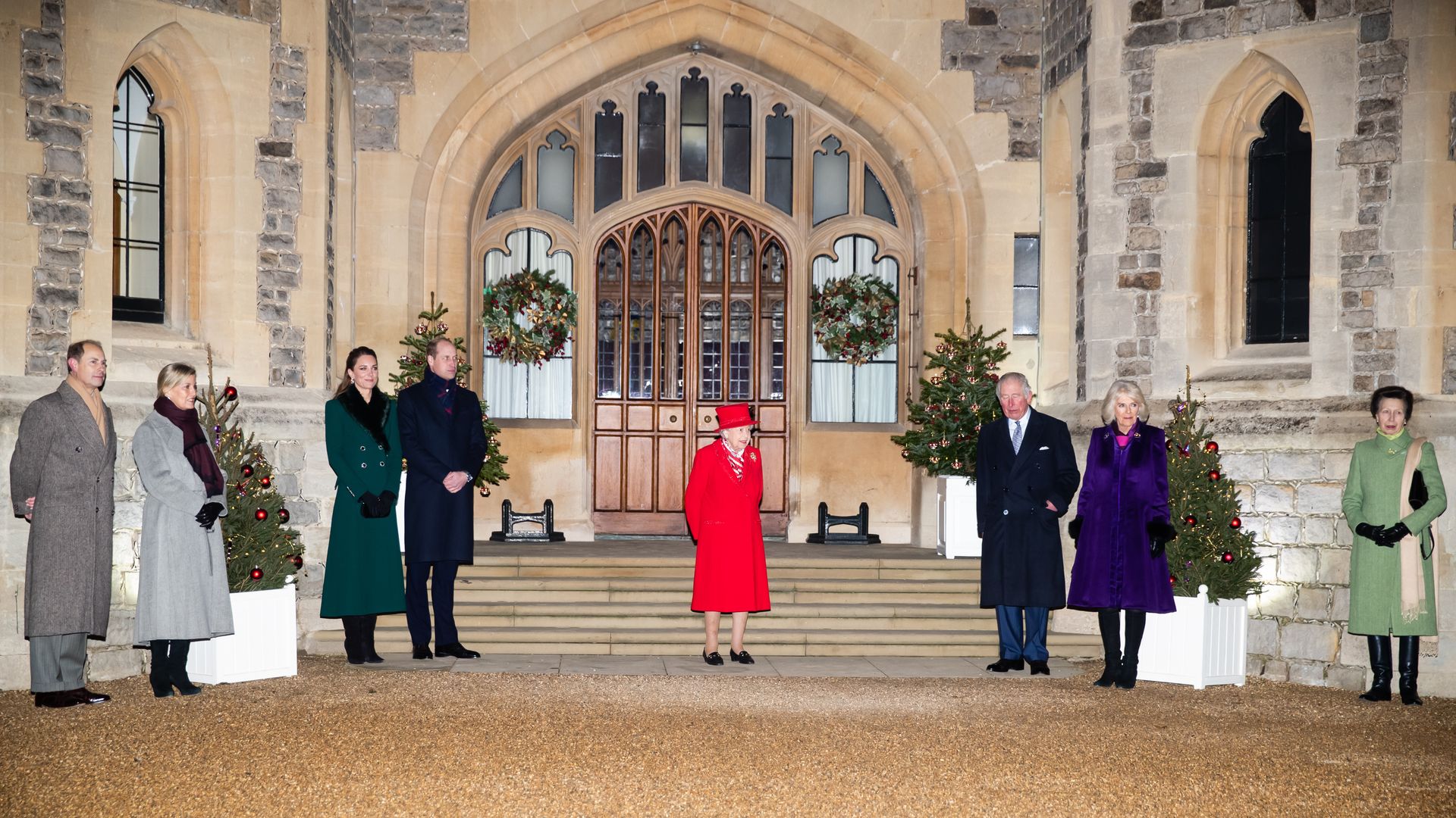Royals standing outside Windsor Castle at Christmas to thank volunteers