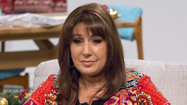 Jane McDonald sitting in an armchair and looking sad