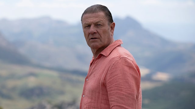Sean Bean wearing a salmon shirt as Reggie in This City Is Ours