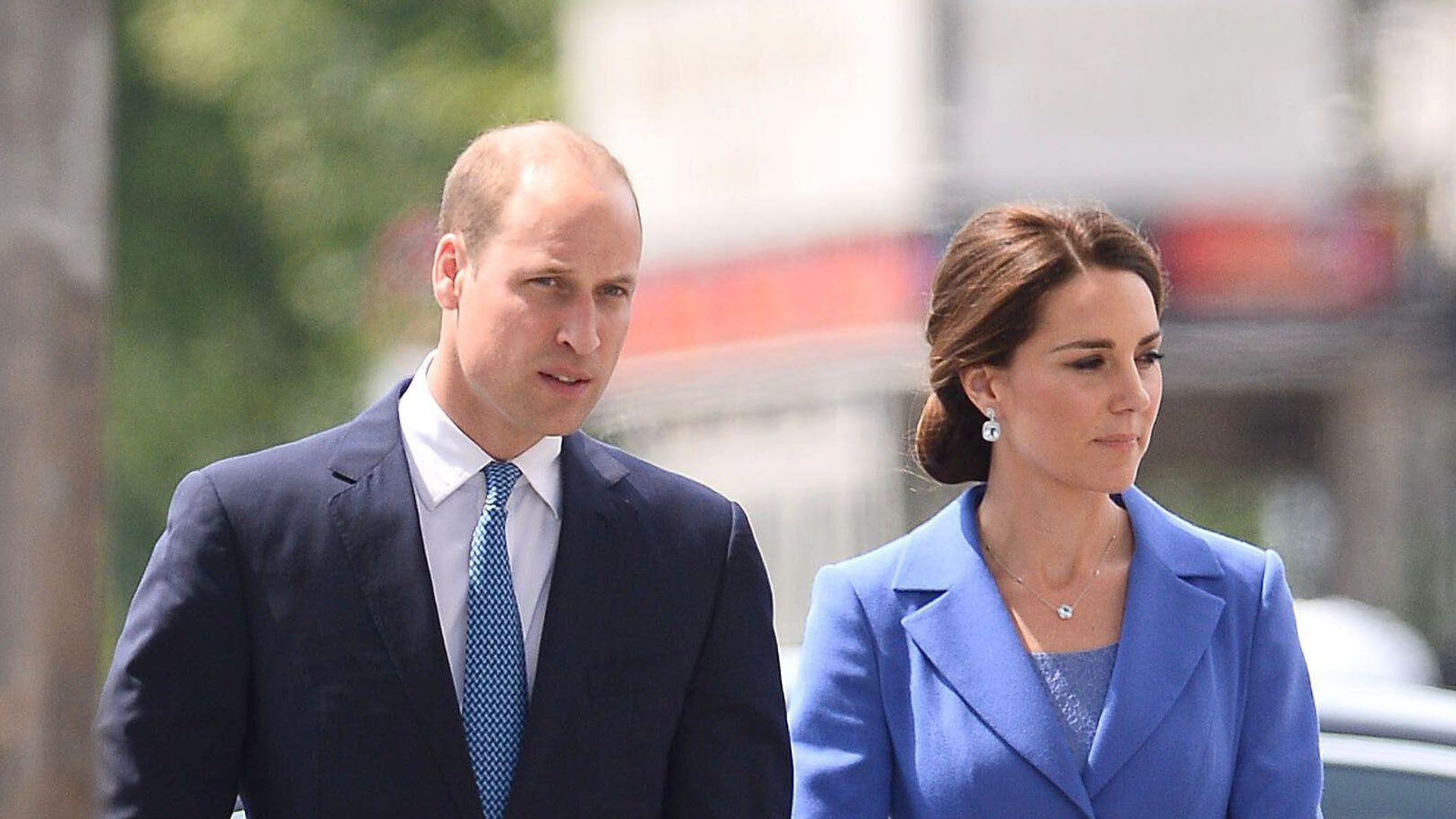 woman in blue dress man in navy suit