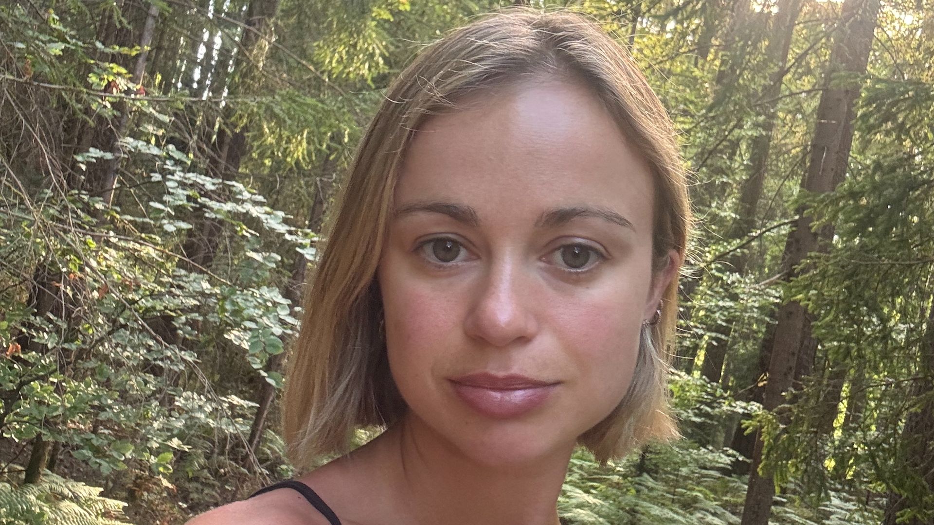 Amelia Windsor taking a selfie in a forest