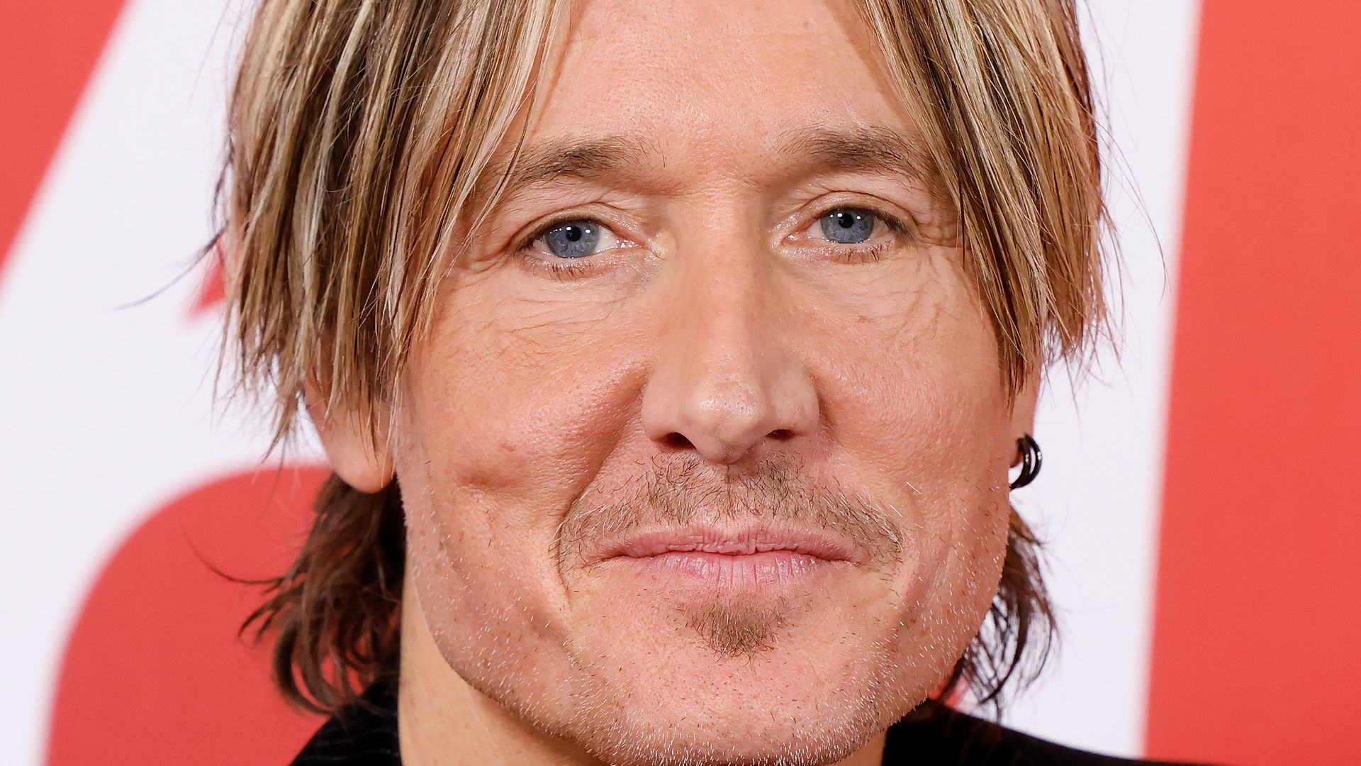 photo of keith urban in black jacket no shirt