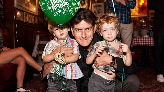 Charlie Sheen poses with his twins Max and Bob