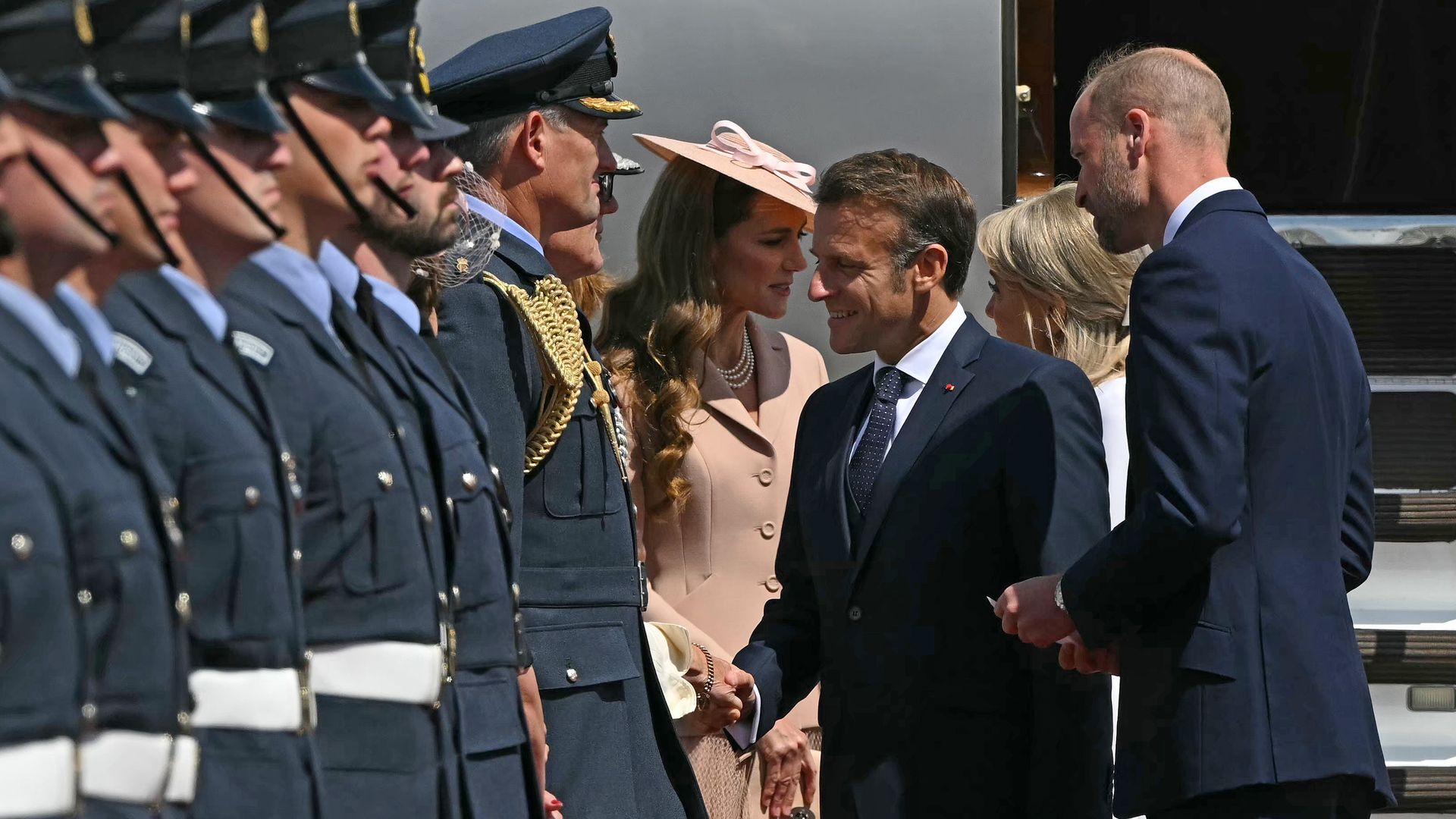 Emmanuel Macron shaking hands with people; Prince William and Kate Middleton are with them