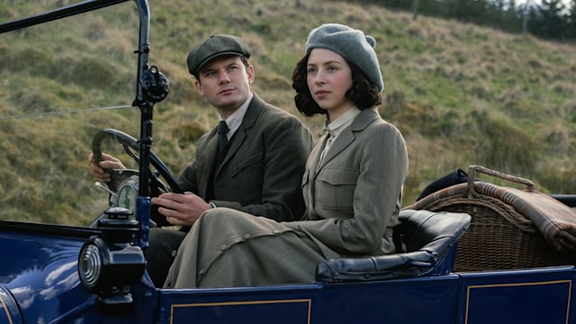 man and woman driving car