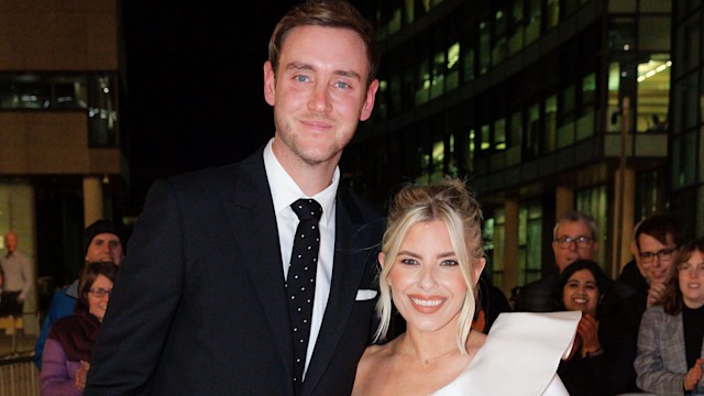 Stuart Broad in a suit with fiancee Mollie King in a white one-shouldered dress