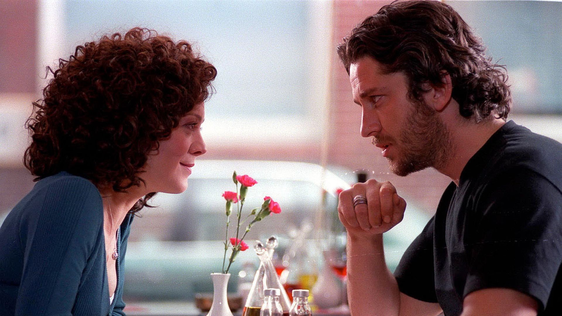 man and woman holding hands in cafe