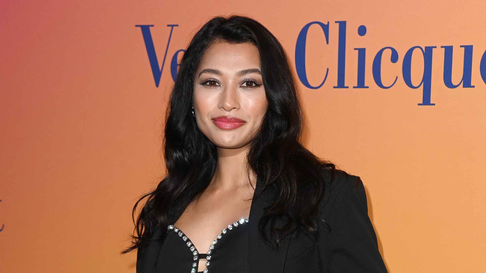 Vanessa White in a black outfit at a red carpet event