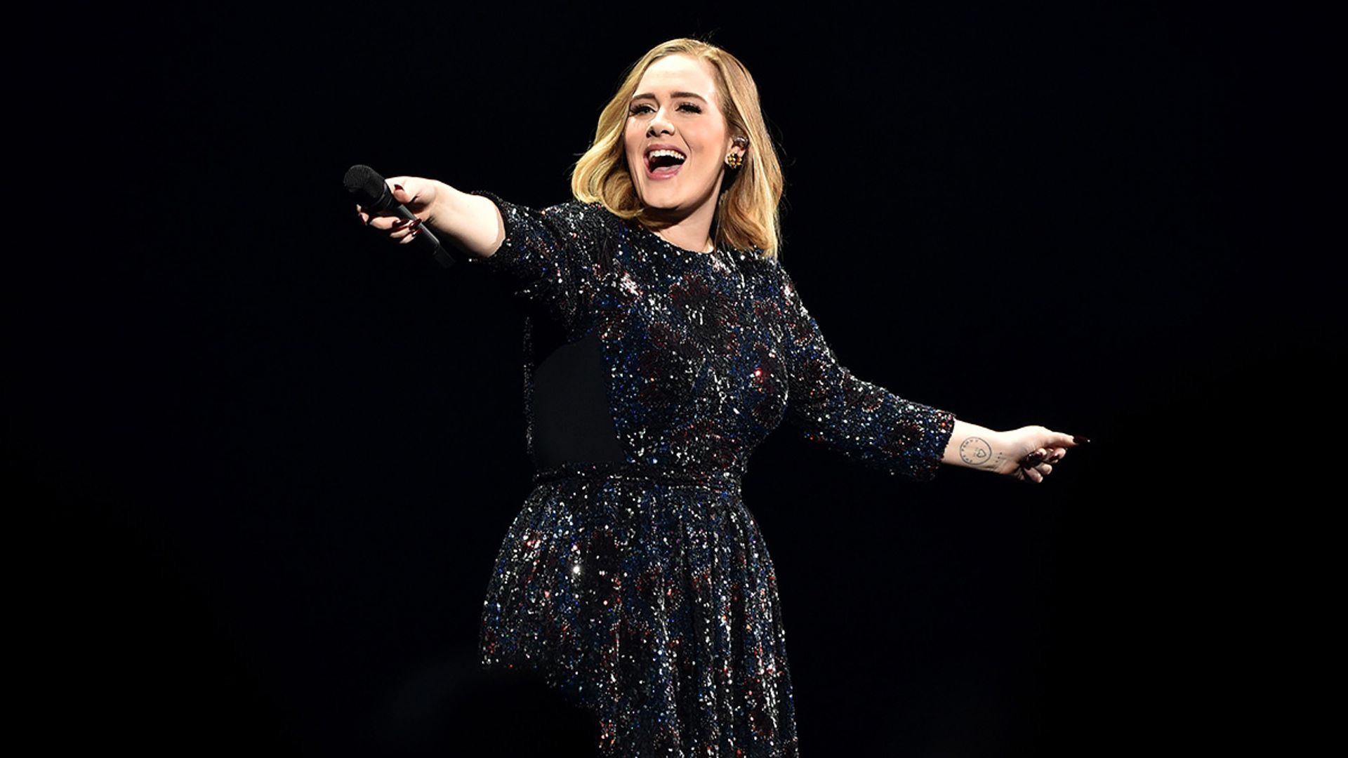 adele performing on stage 