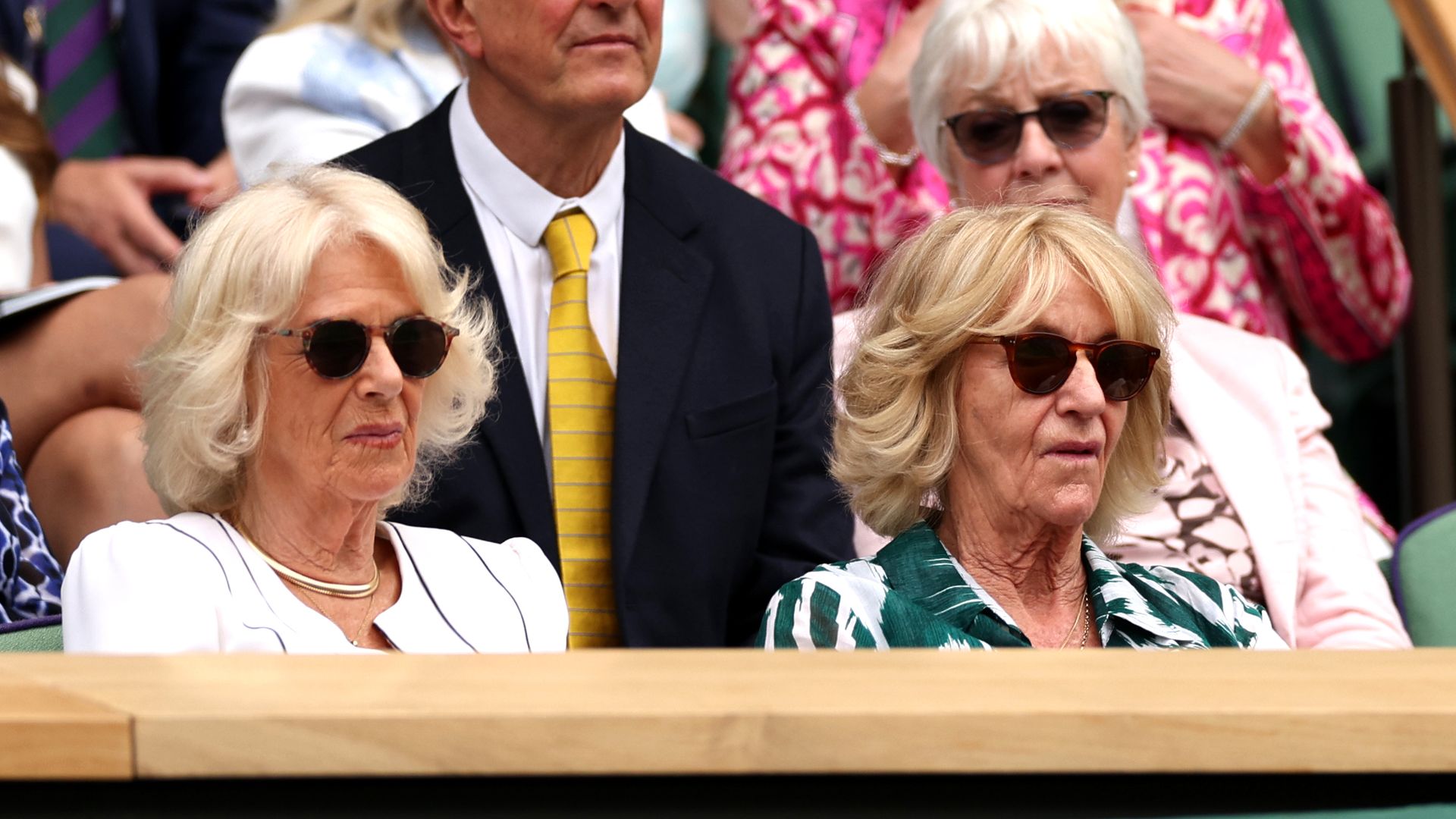 two women watching tennis match 