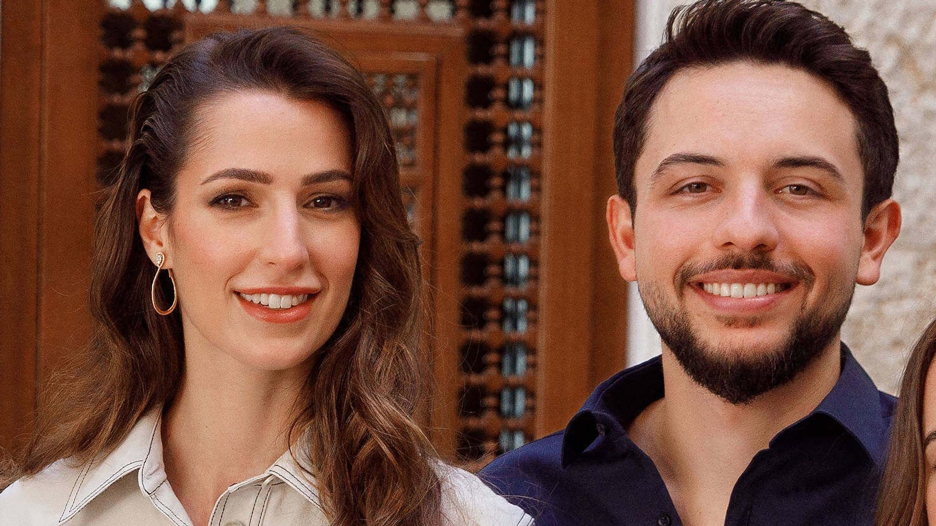 Princess Rajwa in white next to Crown Prince Hussein in a blue shirt