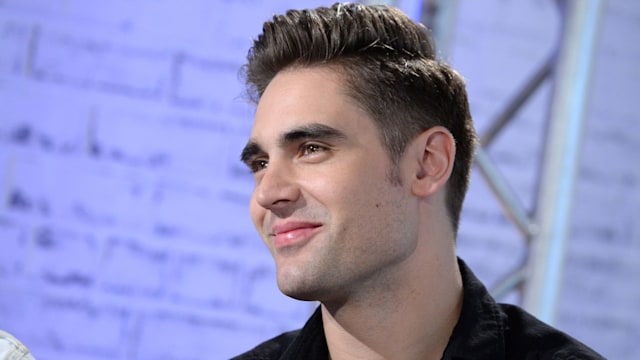 Charlie Simpson smiling against a lilac background