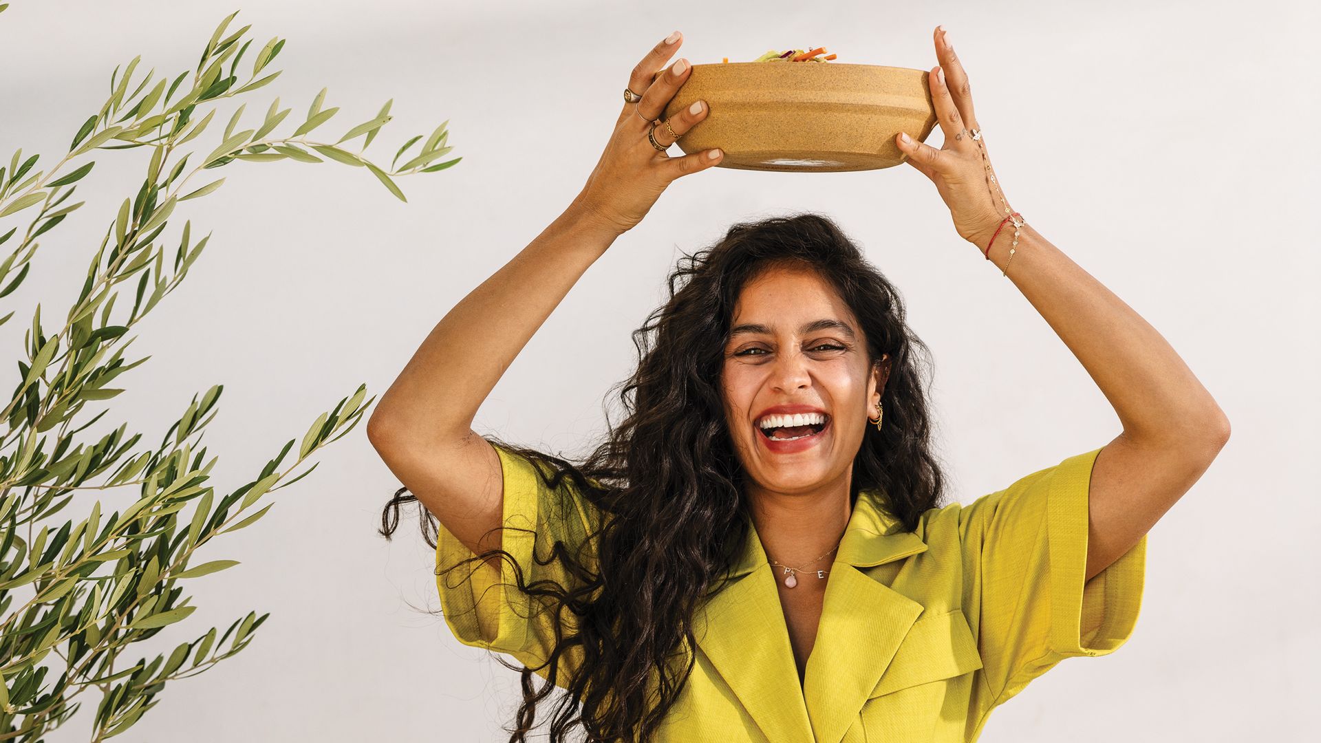 Radhi Devlukia-Shetty holding a bowl above her head