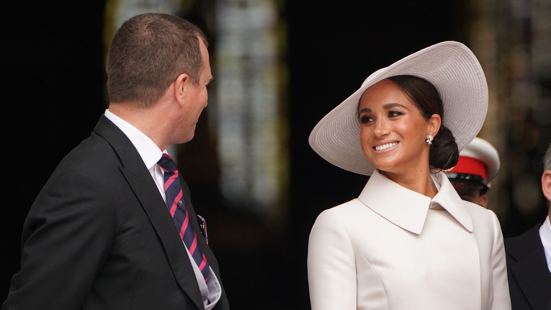 Meghan Markle smiling at Peter Phillips