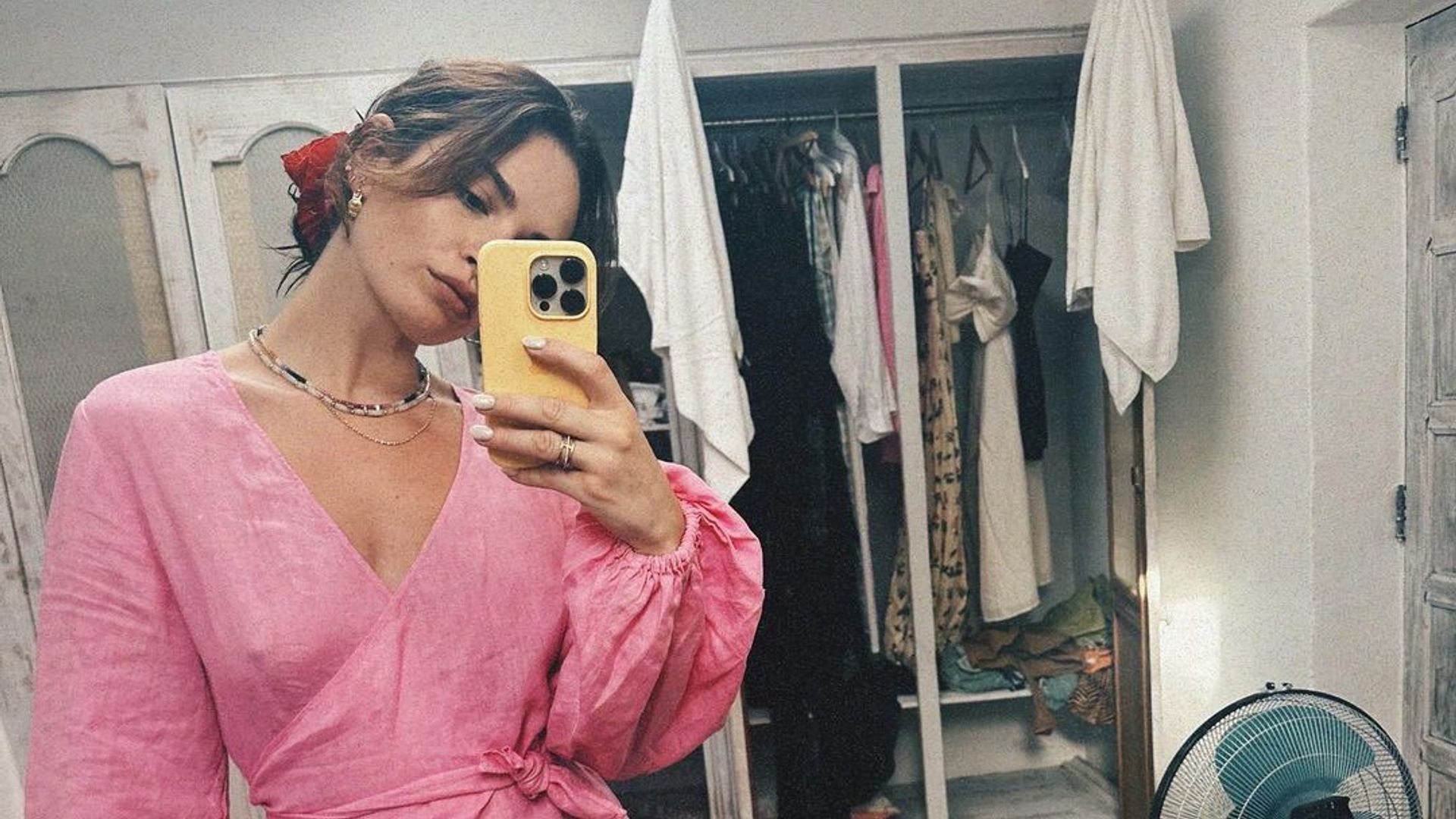 Lily James rocking a pink linen puff-sleeve piece on holiday 