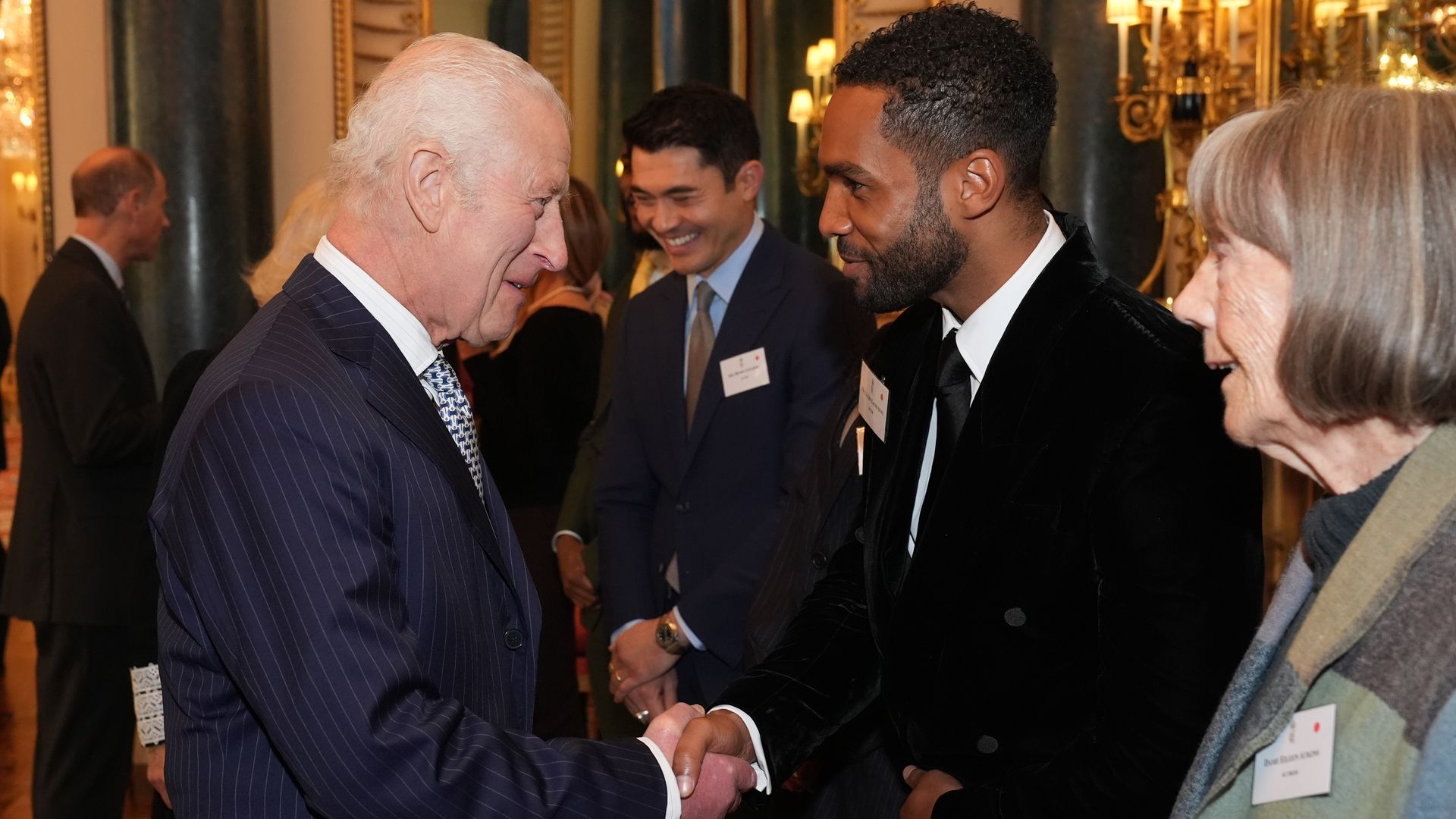 King Charles shaking hands with Lucien Laviscount