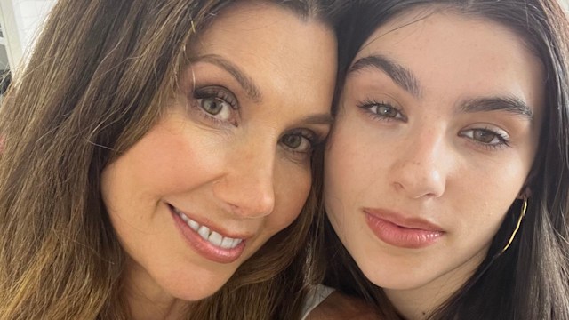 brunette woman smiling with her daughter