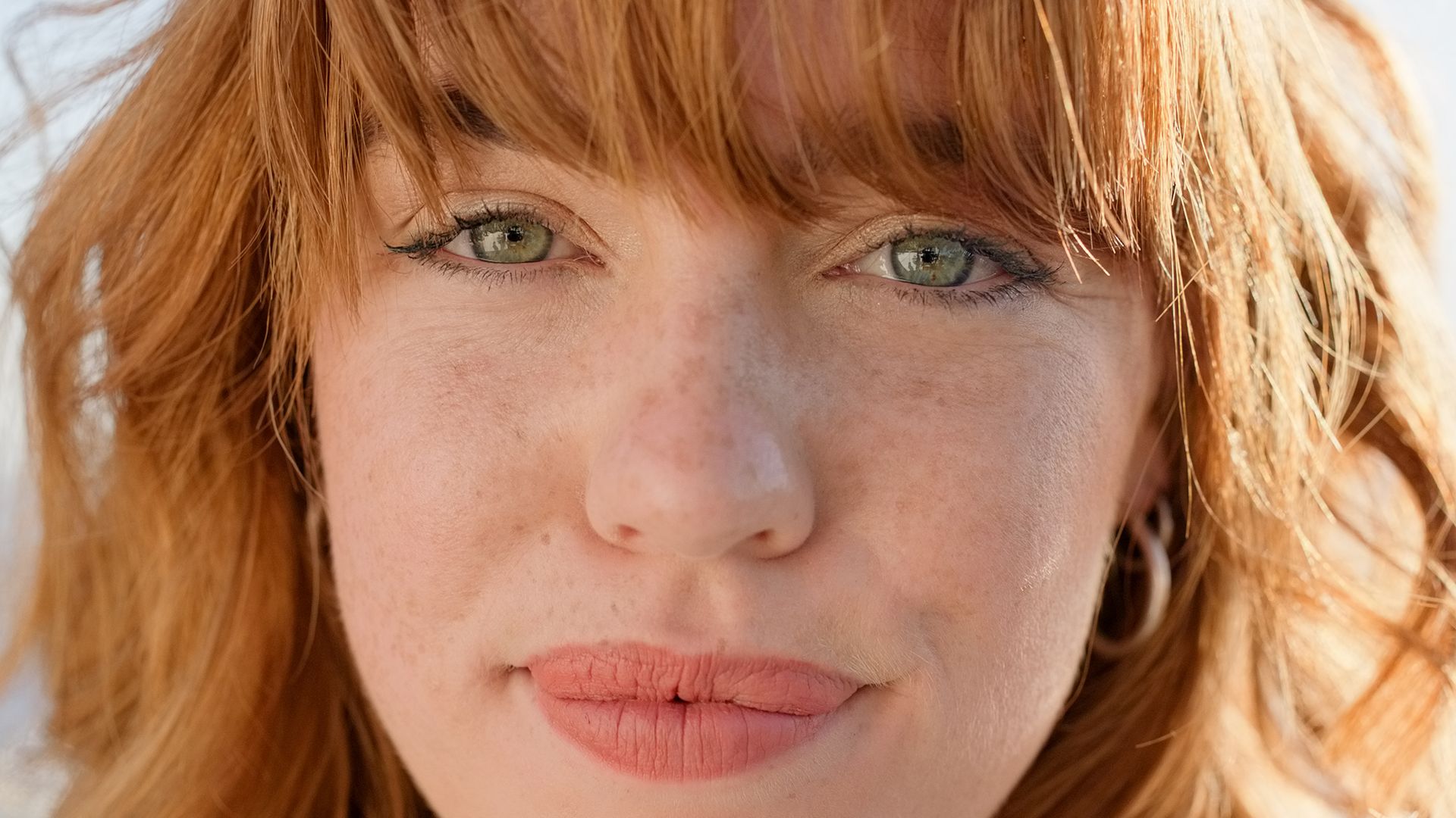 Close up of face of radiant red haired woman with freckles