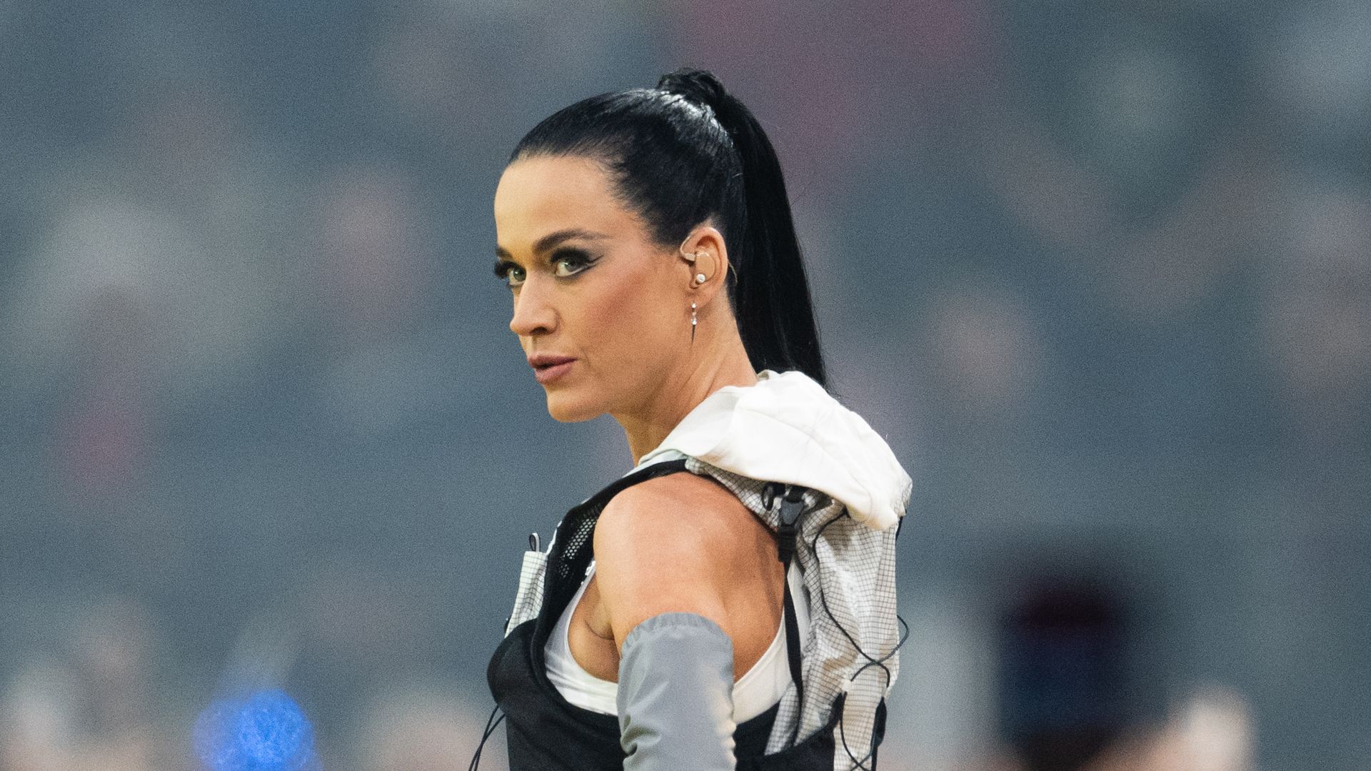 Katy Perry looking over her shoulder looking serious