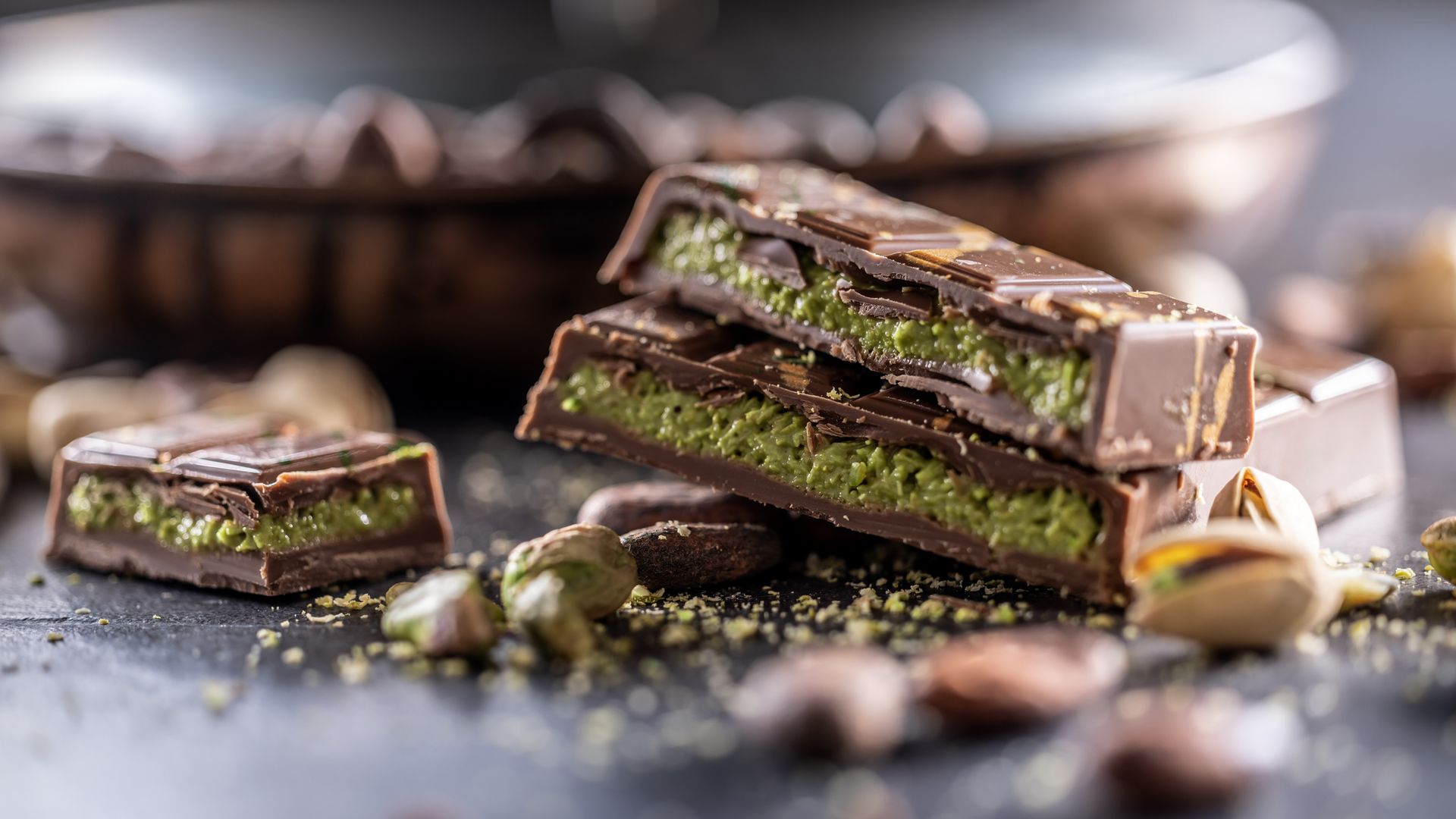 Dubai Chocolate bar with green kadayif and pistachio spread with pistachio nuts - close up