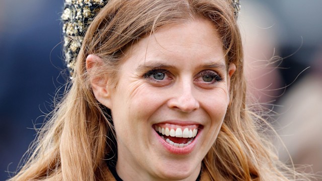 princess beatrice smiling in camel coat and headband 
