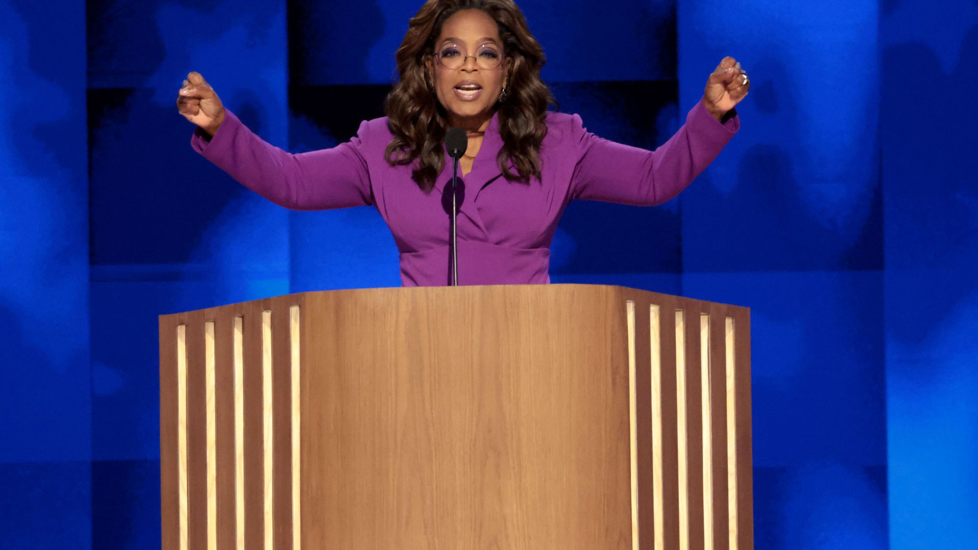 Oprah Winfrey looks phenomenal in waist-cinching purple suit as she makes surprise appearance