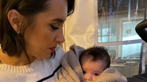 Janette Manrara holding a swaddled baby