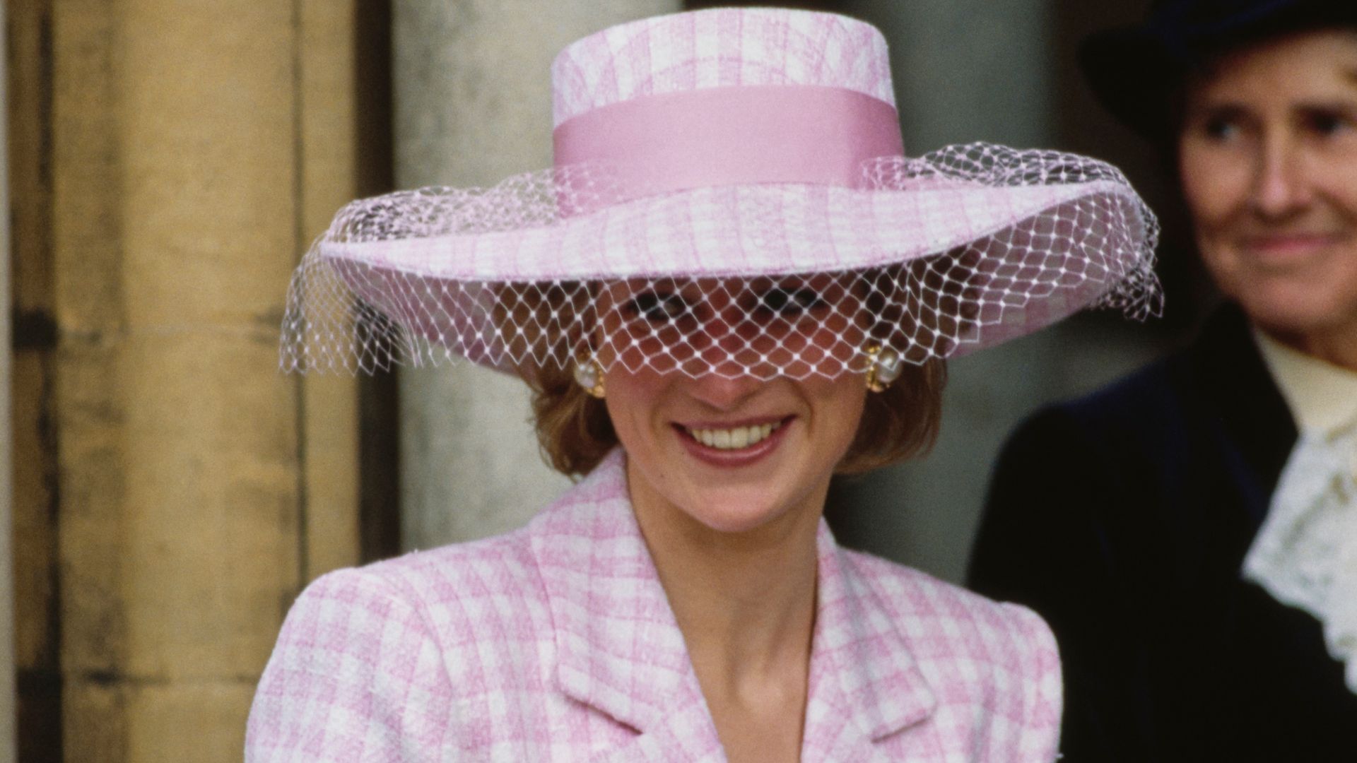 British Royal Diana, Princess of Wales (1961-1997), wearing a pink-and-white checked coatdress with a matching wide-brim hat with a pink bow and white veil,