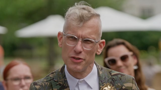 Man with glasses in colourful suit