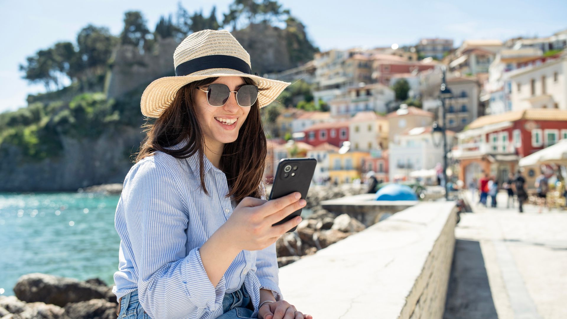 Woman on a summer vacation using her phone.
