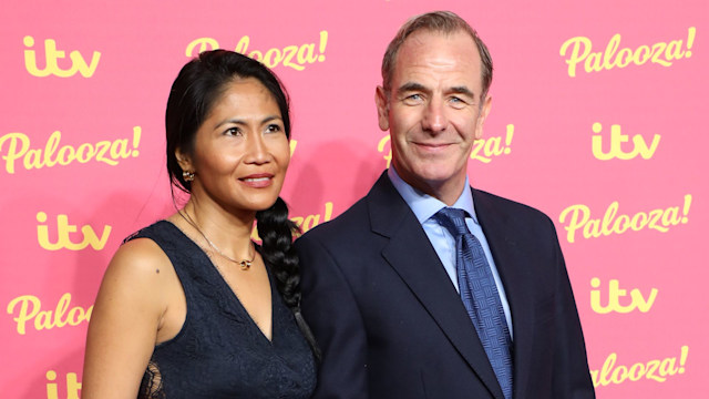 Woman and man holding hands on red carpet